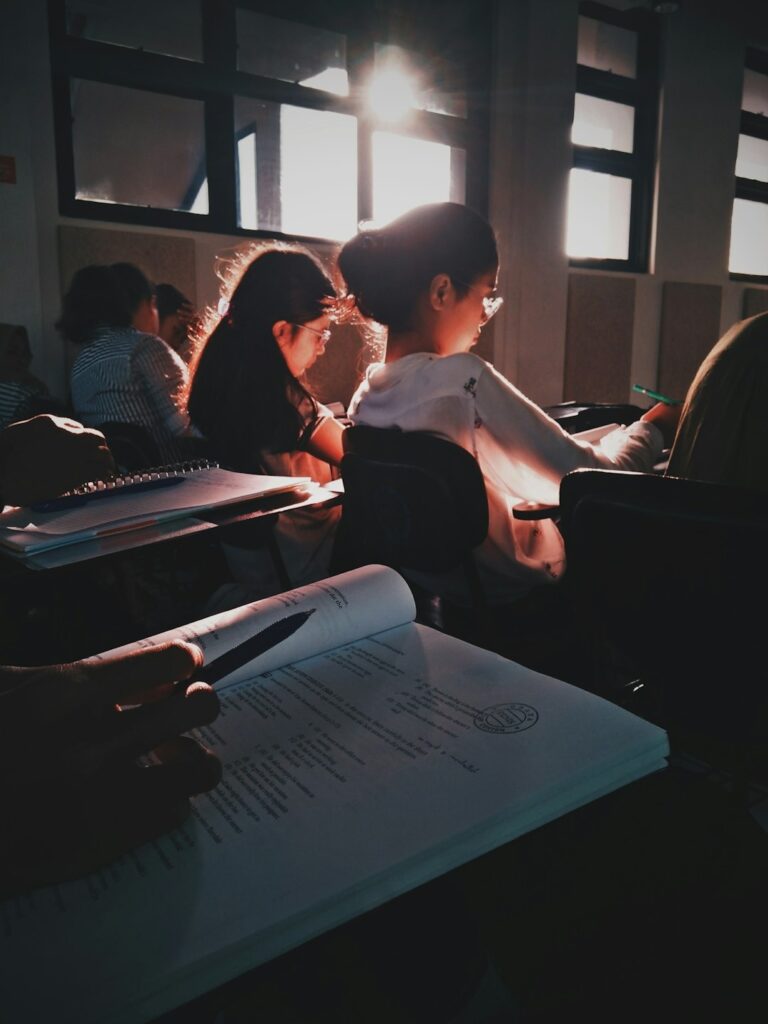 kids sitting at desks with writing journals open